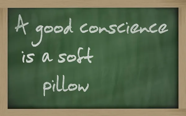 " 良心是软枕头"写在黑板上 — 图库照片
