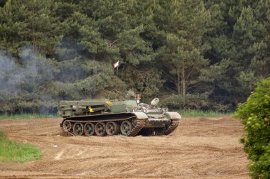 Tank driving on dirty ground clipart