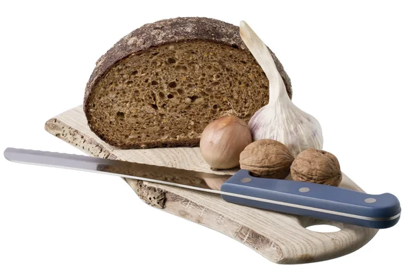 Brown bread on shelf with onion, garlic and walnut — Stock Photo, Image