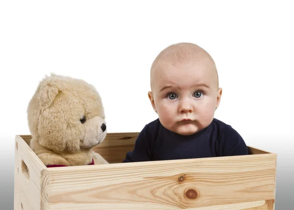 Criança com brinquedo em caixa de madeira — Fotografia de Stock