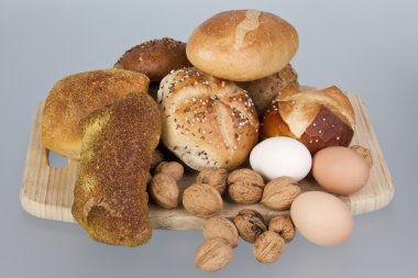 Gem, nuts and eggs on a wooden board clipart