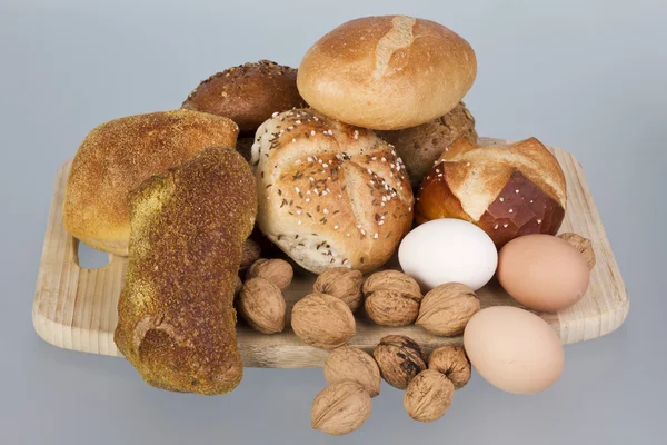 Gem, nuts and eggs on a wooden board — Stock Photo, Image