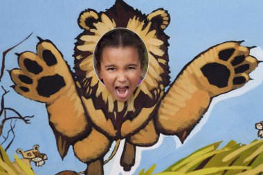 Little Girl Playing At Being A Lion clipart