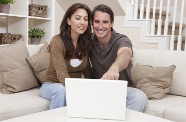 Happy Middle Aged Man & Woman Couple Using Laptop Computer clipart