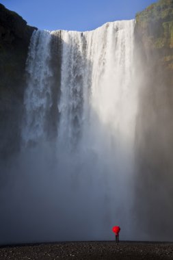 Woman With a Red Umbrella By A Waterfall clipart