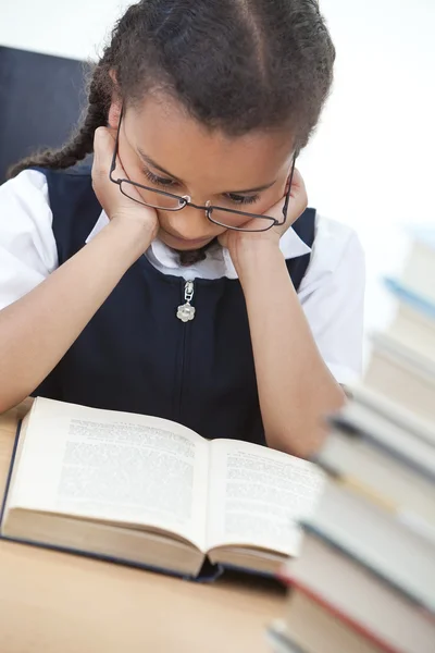 Ung skolflicka läser en bok — Stockfoto