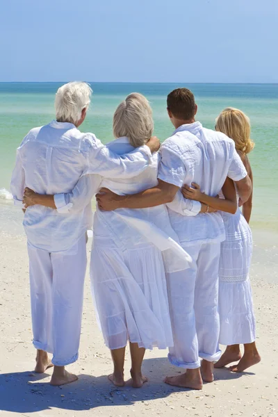 Two Couples Generations of Family Embracing on Tropical Beach — Stock Photo, Image
