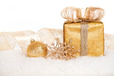 Gift box and gold Christmas decorations clipart