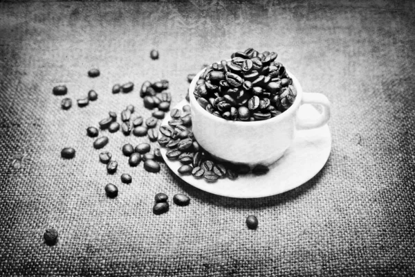 Kubek z kawa na tkanina tekstura tło — Zdjęcie stockowe