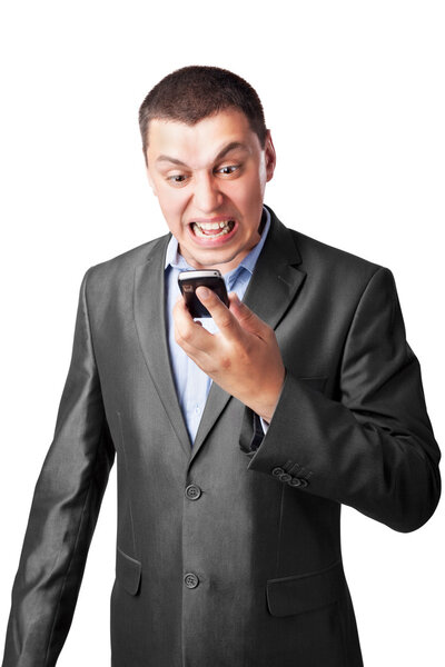 An angry businessman screaming in cell mobile phone isolated on white background