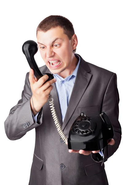 An angry businessman screaming in telephone receiver isolated on — Stock Photo, Image