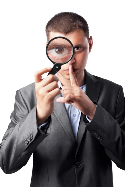 Businessman in a suit looking through a magnifying glass isolate — Stock Photo, Image