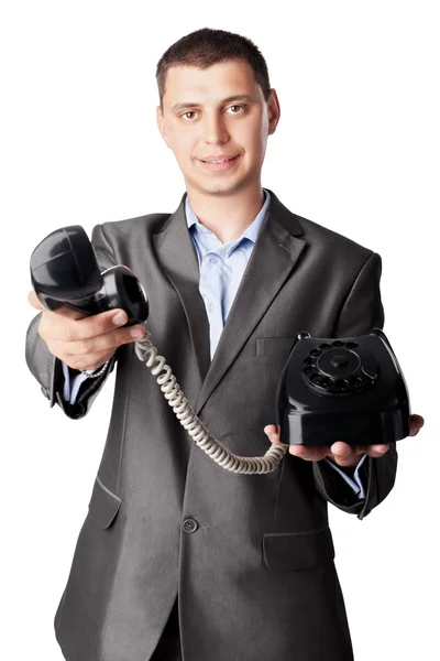 Бизнесмен держит телефонный приемник изолированным на белом бэкгро — стоковое фото