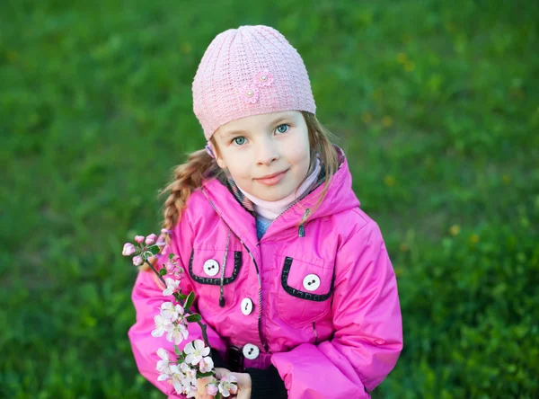 Little girl with branch of flowers — Stock Photo, Image