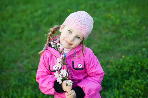 Little girl with branch of flowers — Stock Photo, Image