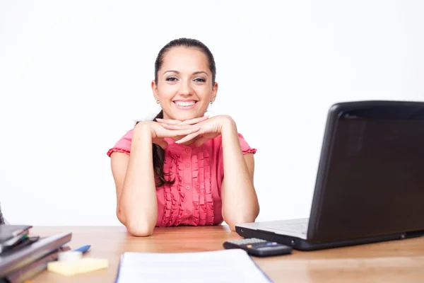 Happy beautiful young business woman sitting at office desk — Stock Photo, Image