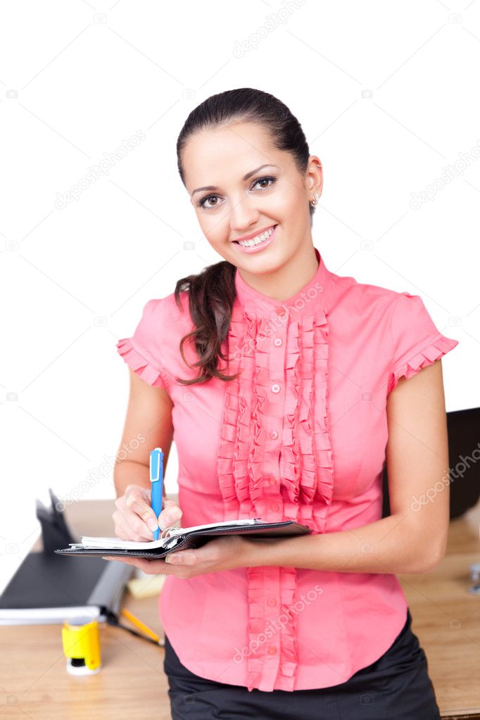 Young happy smiling business woman taking notes at the office