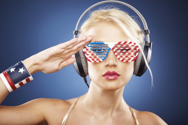 Portrait of blond model in gold swimwear and American inspired a clipart