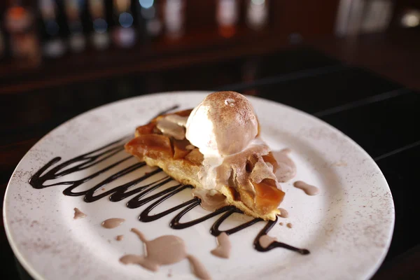 Tasty dessert with apple pie, vanilla ice cream, chocolate sauce — Stock Photo, Image