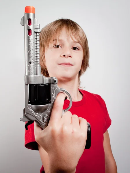 Boy with gun toy — Stock Photo, Image