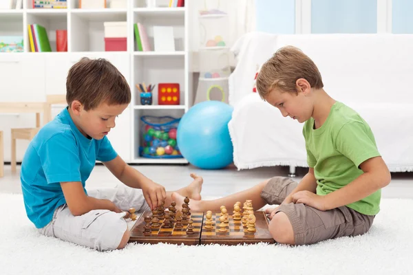 Дети играют в шахматы в своей комнате — стоковое фото