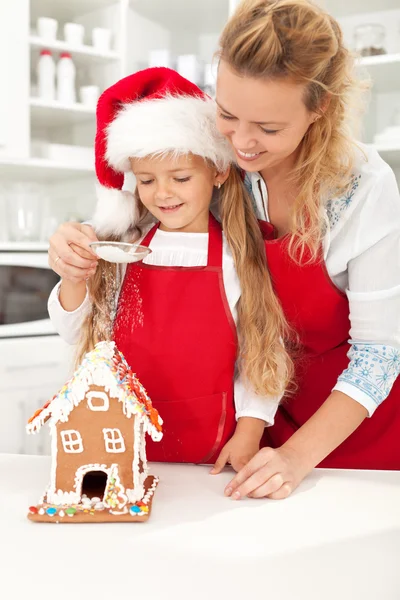 Happy woman and little girl making gingerbread house — Stock Photo, Image