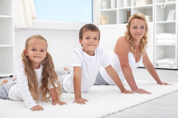 Woman and kids stretching their backs — Stock Photo, Image