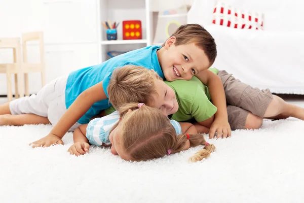 Happy wrestling kids in a pile — Stock Photo, Image