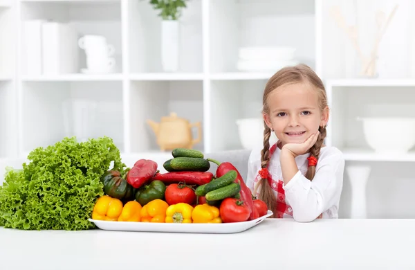 Happy girl with various vegetables — Stock Photo, Image