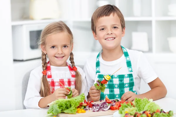 Niños felices preparando una comida en la cocina — Foto de Stock