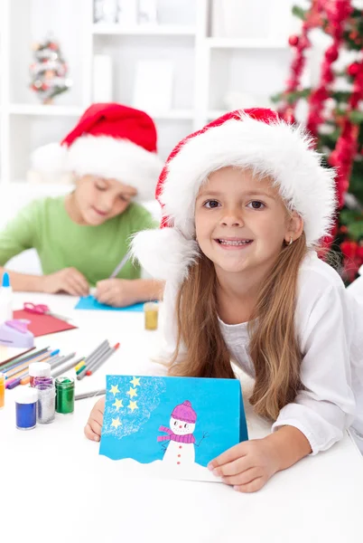 Siblings with lots of presents at christmas time — Stock Photo, Image
