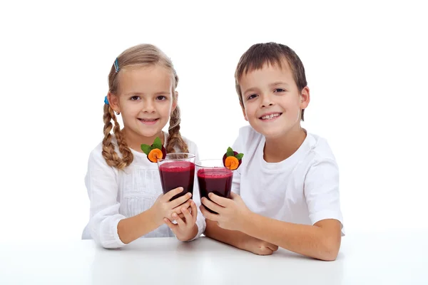 stock image Cheers - kids clink glasses of fresh beetroot juice