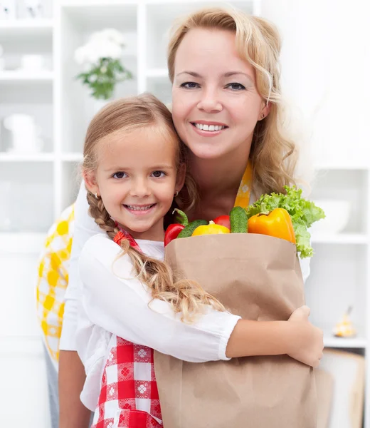 stock image Little girl and woman with the groceries