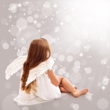 Little angel thinking in divine light clipart