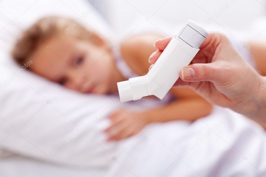 Sick kid with inhaler in foreground