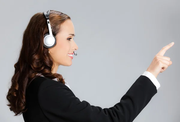 Support phone operator pointing, over grey — Stock Photo, Image