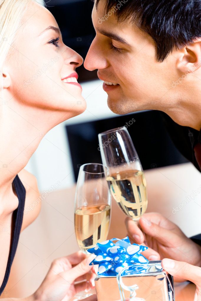 Kissing couple on romantic date or celebrating together at resta