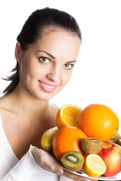Portrait of young happy smiling woman with plate of fruits, isolated on whi — Stock Photo, Image