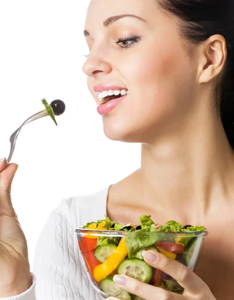 Young happy smiling woman eating vegetable salad, isolated — Stock Photo, Image