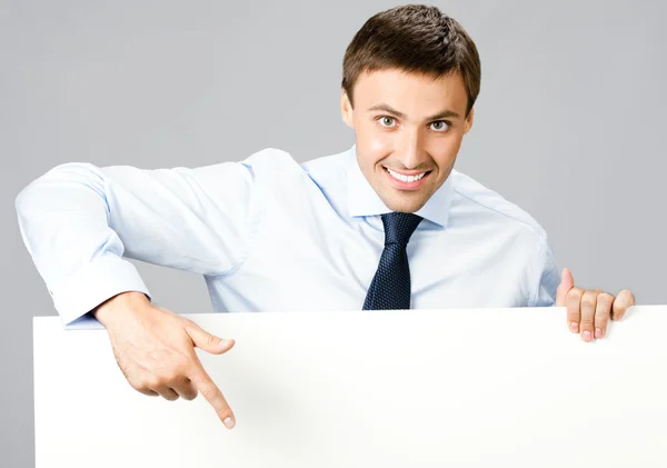 Business man showing blank signboard, over gray — Stock Photo, Image