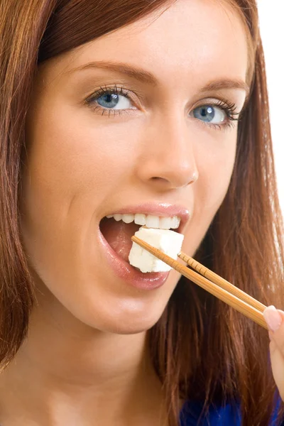 Portrait of young woman eating brynza or cheese, isolated — Stock Photo, Image