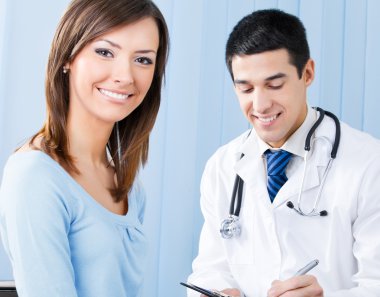 Smiling patient and doctor at office clipart