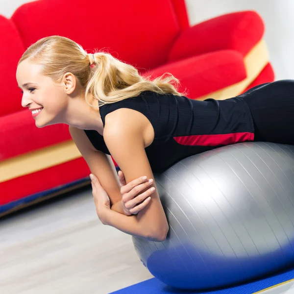 Woman exercising with fit ball, at home Stock Picture