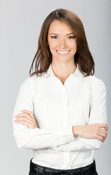 Счастливая улыбающаяся деловая женщина, над серым — стоковое фото
