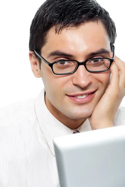 Young happy smiling businessman in glasses working with laptop, — Stock Photo, Image