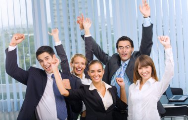 Happy successful gesturing business team at office clipart