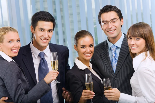 Stock image Happy smiling young businesspeople celebrating with champagne at