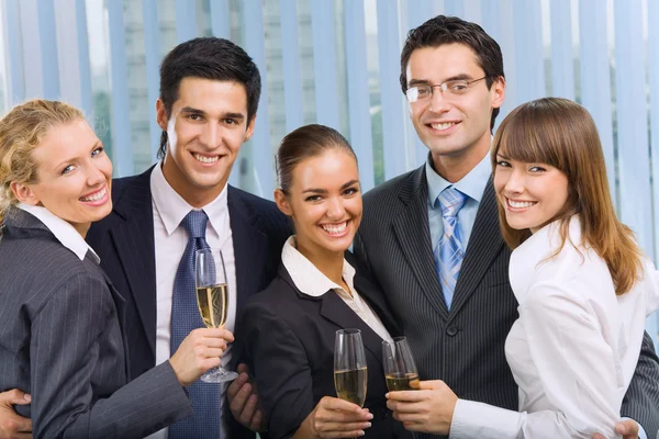 stock image Happy smiling young businesspeople celebrating with champagne at