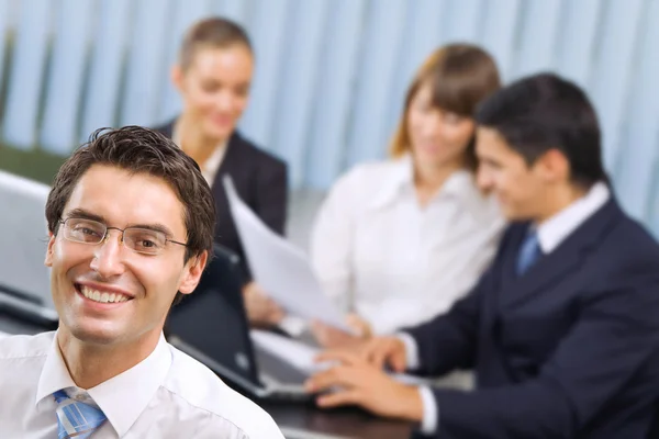 Portrait of successful businessman and business team at office m Stock Photo