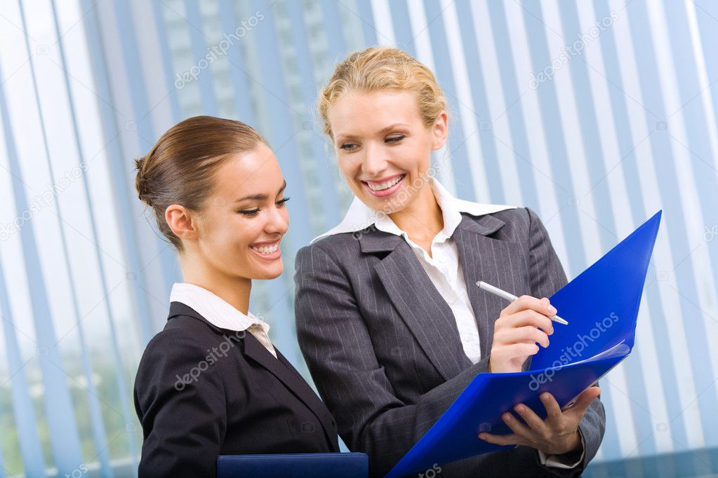 Two businesspeople working with documents at office